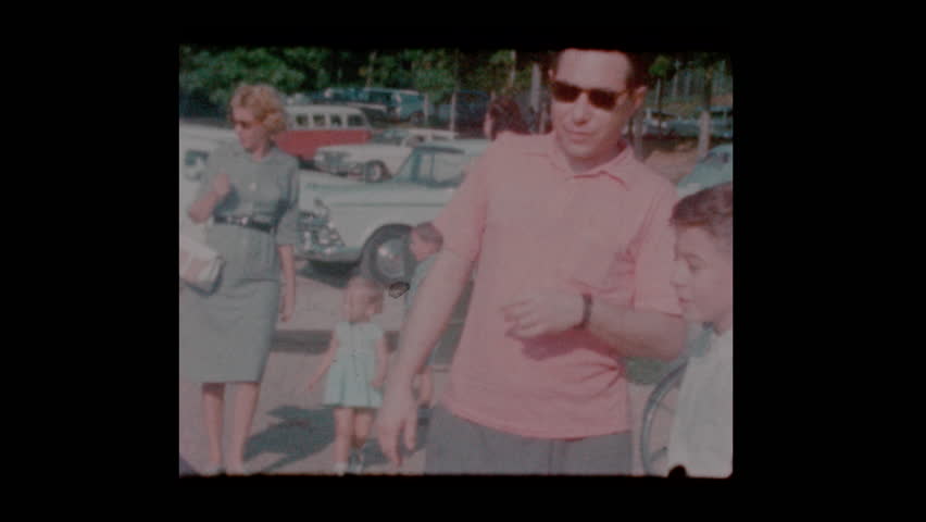 1963 Family in parking lot with vintage antique cars
