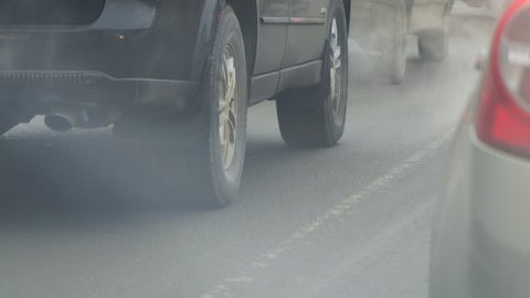 Cars in traffic. Exhaust fumes from the exhaust pipe