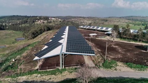 Aerial footage over chicken farm covered with solar panels in northern Israel