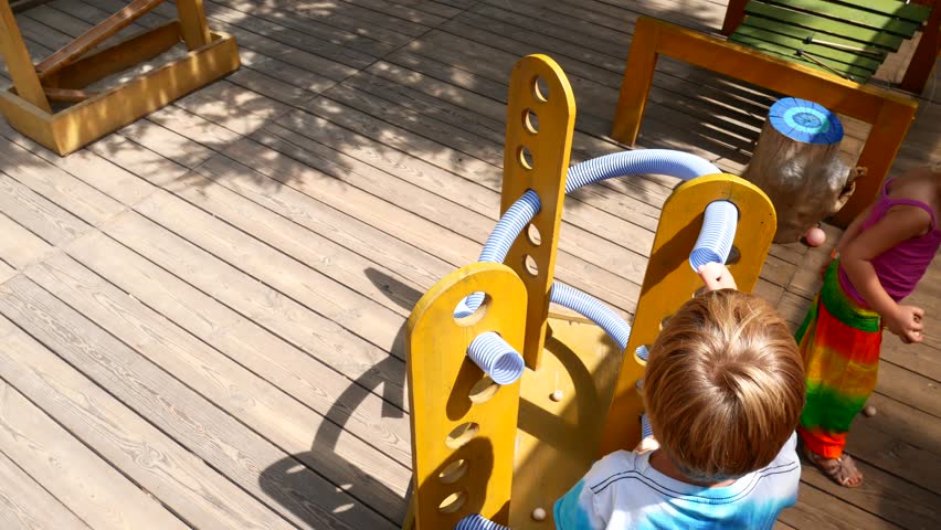 Preschool children play in the playground.