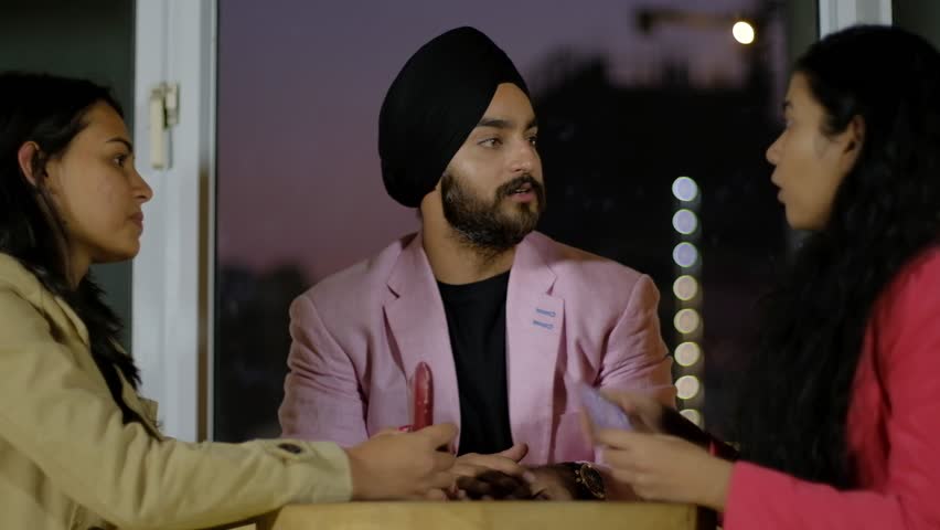Indian friends discuss love hearts and proposals as they listen to some else off camera for instructions and getting happy to propose on valentine