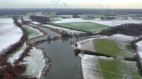 The Schwafheimer sea is a nature conservation area in Moers in a former flood gutter of the river Rhine in Germany - Aerial view with the chimneys of Duisburg city in the background.