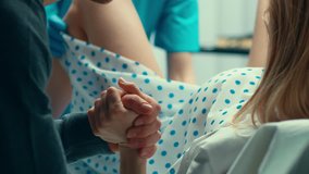 In the Hospital Woman in Labor Pushes and Gives Birth, Baby Comes out, Obstetricians Assist Delivery, Husband Supports His Wife. Close-up Footage - Powered by Shutterstock - Get 15% off with code: PIKWIZARD15