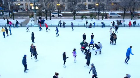 CHICAGO, IL - FEBRUARY 2, 2019 - People ice skating on an ice rink in Millennium Park, in downtown Chicago. Urban leisure activities