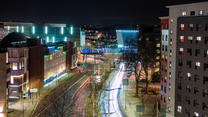 Time lapse of car light trails in futuristic city center at night