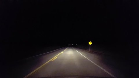 Driving Rural Countryside Road Into the City at Night.  Driver Point of View POV Entering Urban Lights From Country Street