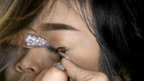 Closeup of a girl having makeup applied