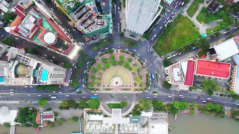 Time lapse Aerial city view, flying over a city, a suggestive perpendicular aerial video above a traffic roundabout with a lot of traffic, Vietnam Ho chi minh city. Timelapse