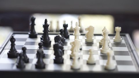 Businessmen play chess by holding a black king. Kill the opposing king. Strategies for doing business using as background business concept and Strategy concept 