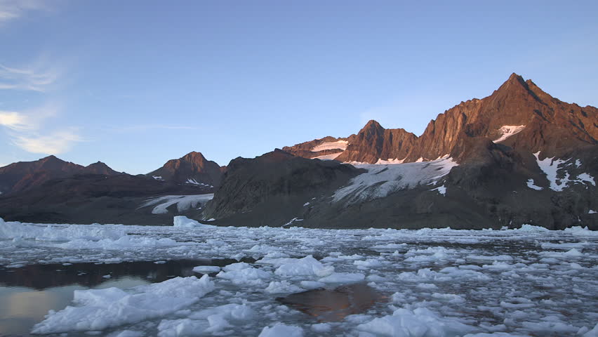 Sunset on the Arctic Ocean with his icebergs and his mountains, Greenland