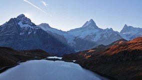 Time lapse clip. Morning view of Bachalp lake / Bachalpsee, Switzerland. Autumn sunrise in Swiss alps, Grindelwald, Bernese Oberland, Europe. Full HD video (High Definition).