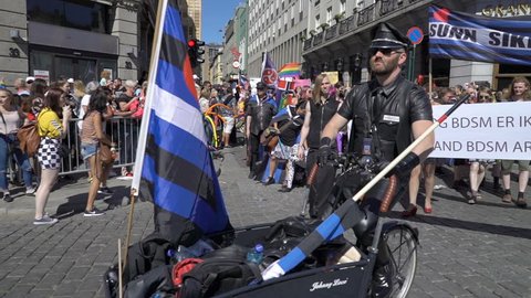 OSLO, NORWAY - JUNE 30, 2018: The guys from the BDSM community in leather suits. The Pride Parade, the highlight of Oslo’s Pride Week, is a huge, vibrant parade filling the city’s streets. Slow motion