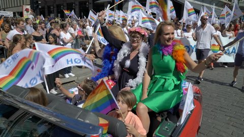 OSLO, NORWAY - JUNE 30, 2018: Huge costume crowd sings and dances. The Pride Parade, the highlight of Oslo’s Pride Week, is a huge, vibrant parade filling the city’s streets.