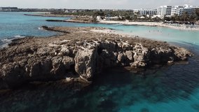 Aerial Footage Clear Waters Nissi Beach Island of Cyprus. Aerial View of Ayia Napa Holiday Vacation Beach Life.