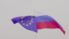 VIDEO flag of the European Union and Russia against the sky. The concept of friendship and reconciliation.
