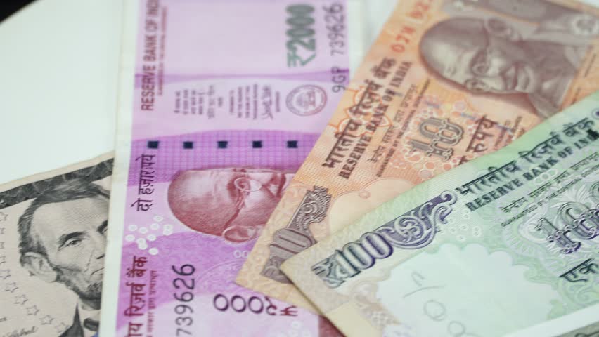 India money and US dollar on the rotating table. 4K