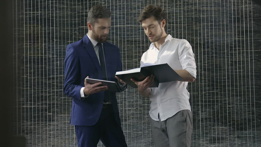 Two businessmen talking about corporate topics. 