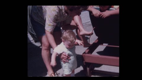 1971 Grandmother teaching happy baby boy grandson how to walk