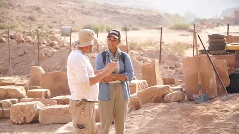 Petra / Jordan - October 2018: Archaeologist talking to a young women at the Qasr Al-bint excavation site in Petra, Jordan.