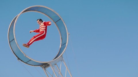 TAMPA, FL - FEB 7, 2019: Circus performer jumping in slow motion on wheel of death daredevil act, taken on February 7, 2019. 
