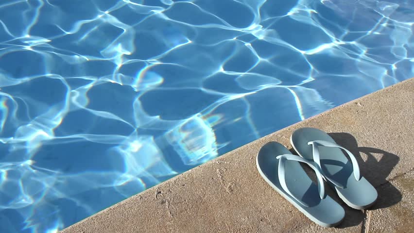 Pair of flip flops by the poolside - Summer vacation - Relaxing travel concept
