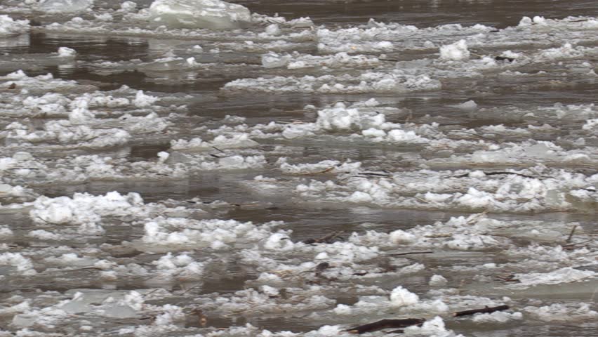Ice jam breaks in spring thaw causing flooding down river towards town