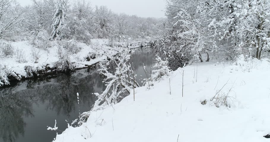 Snow covered creek and park in the winter