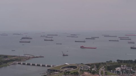 Time lapse parking of large cargo ships in the harbor of Singapore.