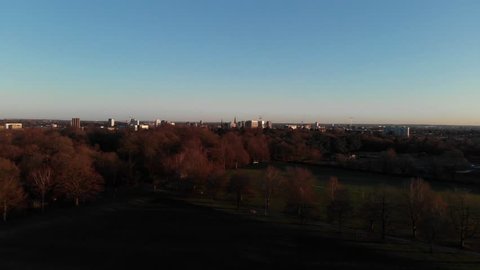 Drone Aerial View, Slow Descend Into Wooded Park From Coventry City Of Culture Cityscape.