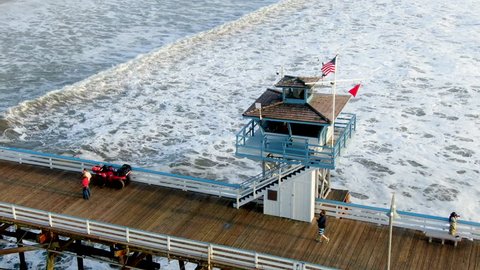 Aerial view of San Clemente Pier with lifeguard tower for surfer. San Clemente city in Orange County, California, USA. Travel destination in the South West Coast. Famous beach for surfer. 01/25/2018