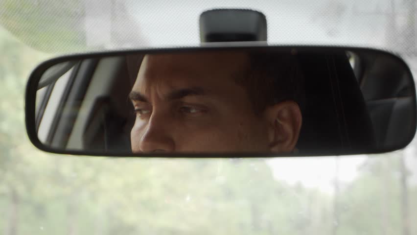 Young Caucasian Man Driving Car Looking in Rear View Mirror Royalty-Free Stock Footage #1023742183