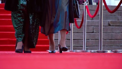 Two actresses are walking on the red carpet, close up