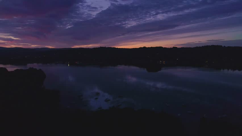 Sunrise and silhouettes flying over lake windermere Lake District