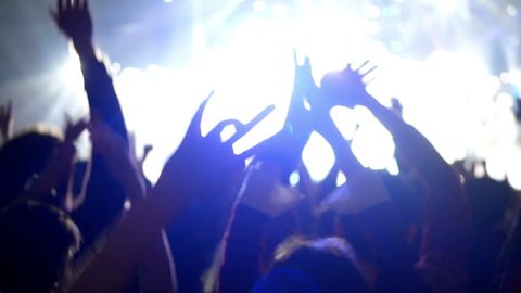 Night rock concert crowd cheering hands music