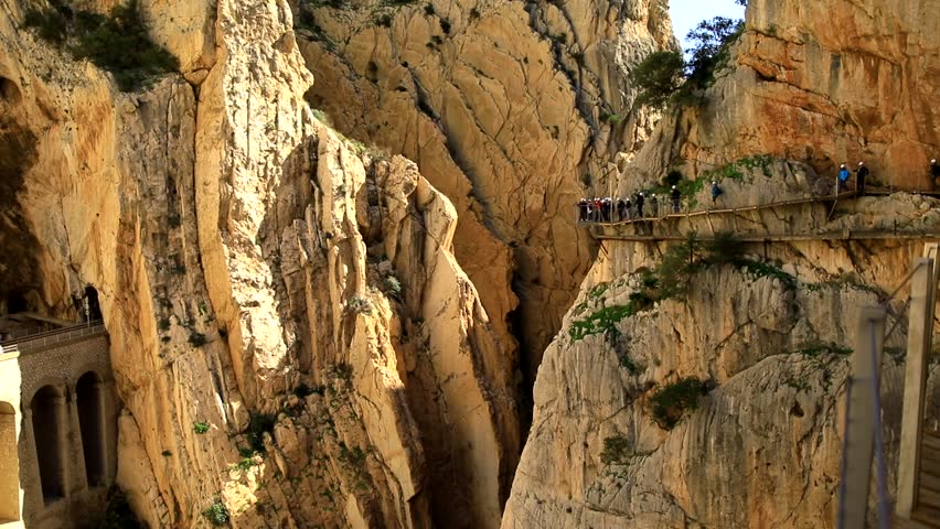 Group of turists on dangerous bridge.  Ground-level view of Camenito Del Rey in Malaga. Spain travel. 