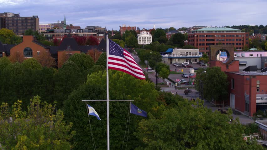 American Flag Waving in New England Town, Burlington Vermont Sunset | Shutterstock HD Video #1023759418