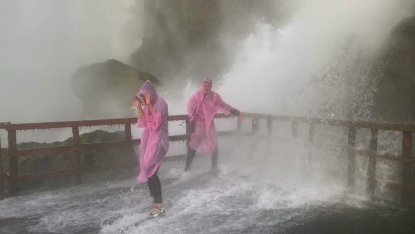 Couple Under Waterfall at Niagara Falls, Laughing Fun Adventure Tourists