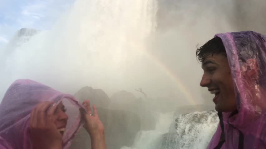 Couple Looks Up at Rainbow at Niagara Falls, Waterfall