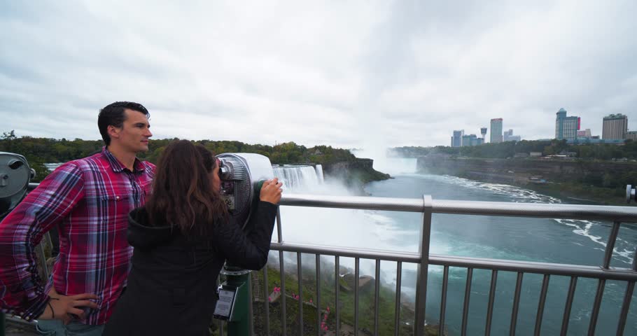 Couple Looks Through Viewfinder at Niagara Falls, Tourists