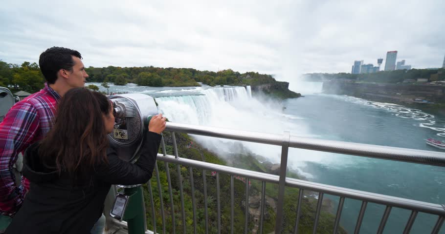 Couple Looks Through Viewfinder at Niagara Falls, Tourists