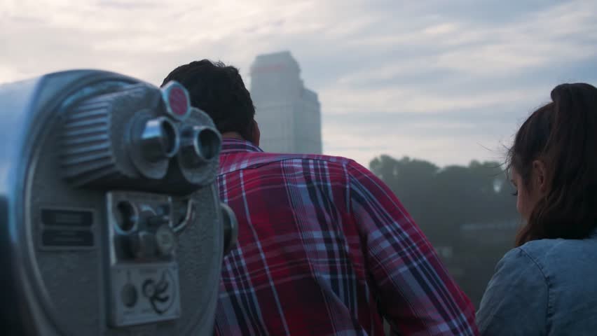 Couple on Bridge Looking at Niagara Falls, Tourists Viewfinder