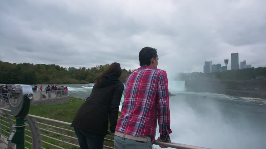 Couple on Bridge Looking at Niagara Falls, Tourists Viewfinder