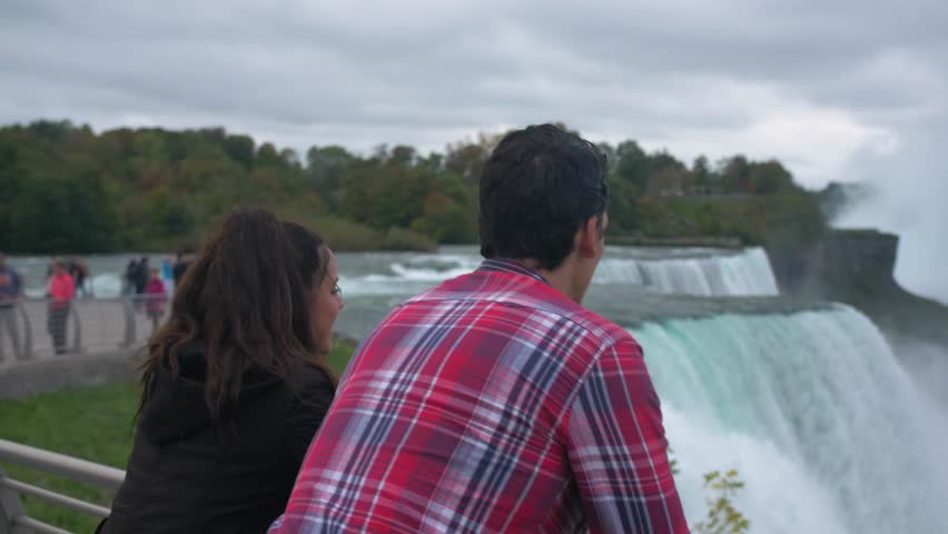 Couple on Bridge Looking at Niagara Falls, Tourists Viewfinder