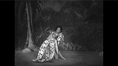 CIRCA 1960s - An exotic South American woman performs a stage dance.