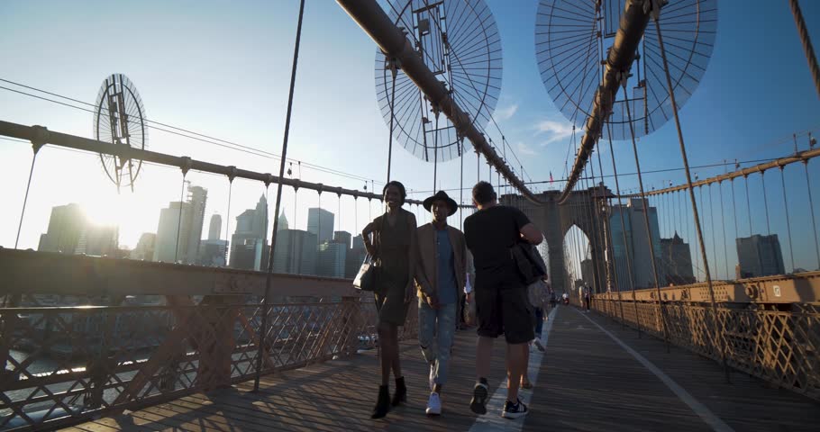 New York, New York / United States - September 18 2018: Young Black Couple Walk Brooklyn Bridge, Lens Flare Sunset NYC Skyline | Shutterstock HD Video #1023767902