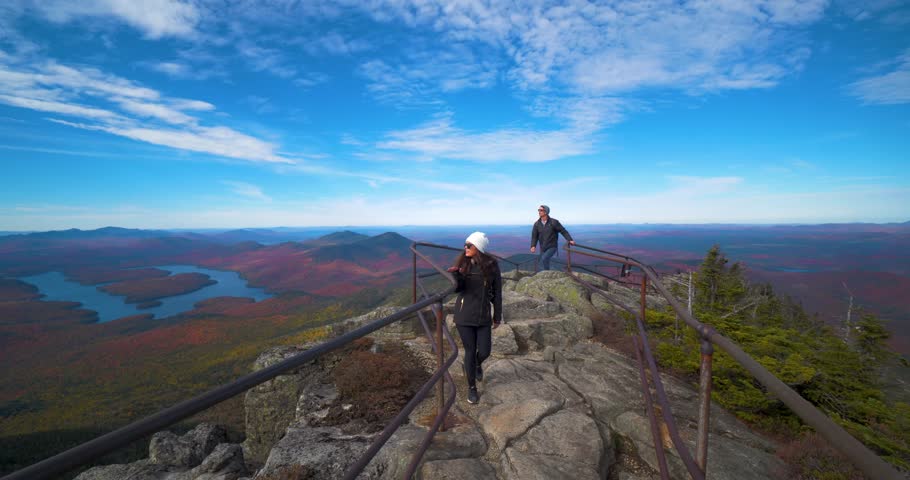 Hiking Couple Exploring Peak of Mountain, Lake Placid NY