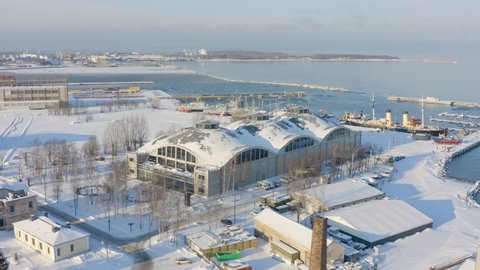 Overview of Seaplane Harbour (Lennusadam) hangars and its port in Tallinn during winter. Aerial shot.