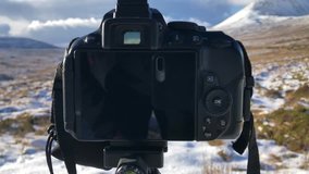 This is a video taken of a landscape photographers point of view just when they are capturing a picture of snow covered mountains in Donegal Ireland in winter. You see the back of the camera.