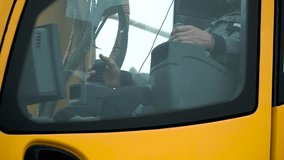 Drivers cab of a yellow crane working on a construction site. Clip. Work the driver of the crane arm in cab