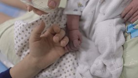 Newborn holding his older brother's finger. Beautiful conceptual video of love and family.
